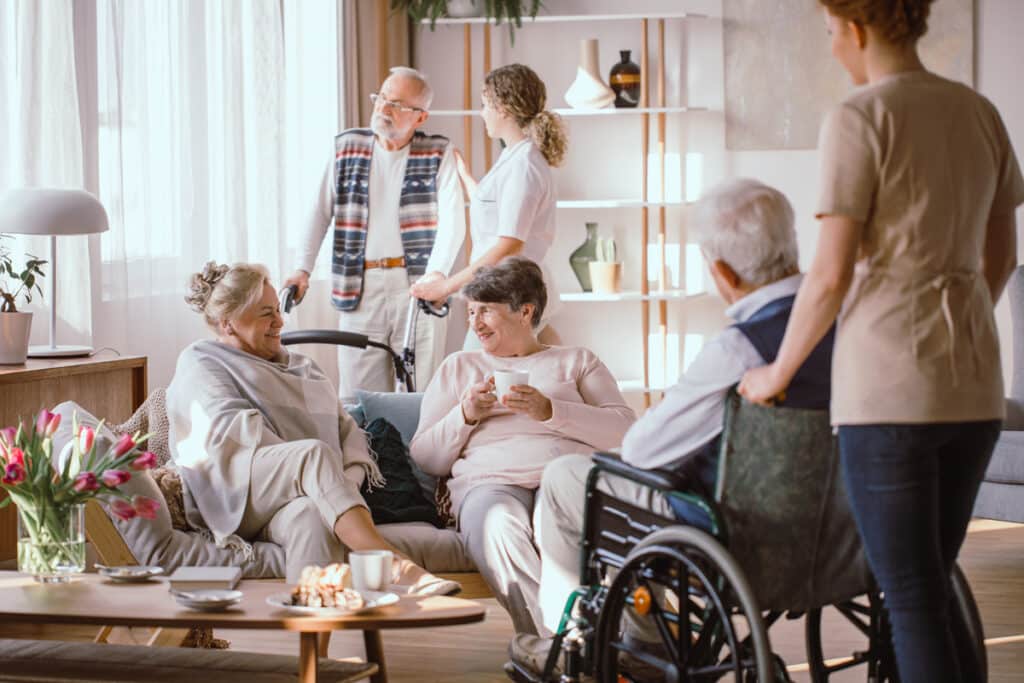 older adults spending time together in a living room at an assisted living facility in Monroe, LA